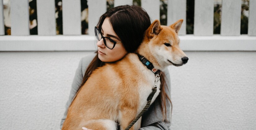 Woman hugs her dog